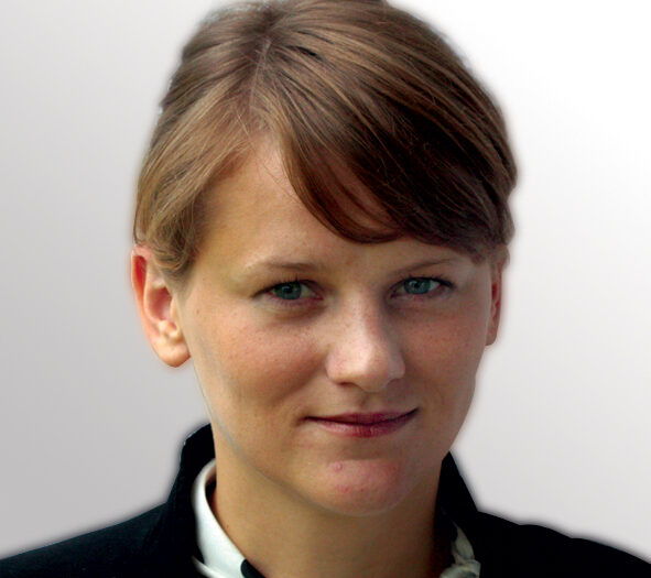 Alicja Dewera-Moczerniuk, M.D. A woman with short brown hair smiles softly, showcasing her confident and approachable demeanor in a bright setting.