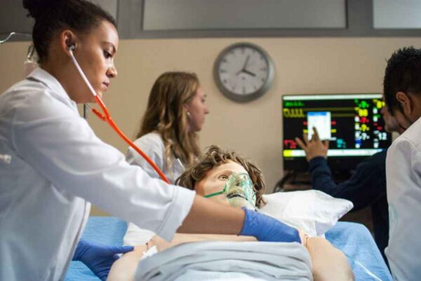 A doctor provides medical care to a patient in a hospital, highlighting the importance of health services and patient support.